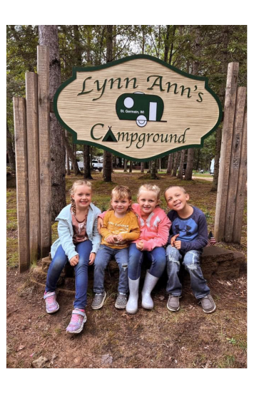 Kids in front of Lynn Ann's Campground sign