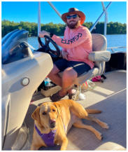 Man boating with his dog